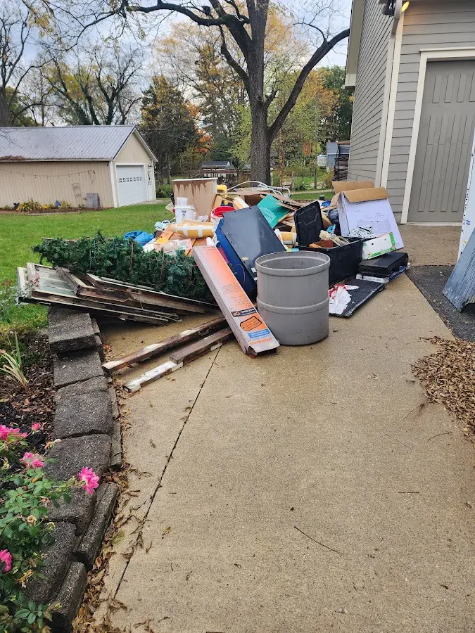 Dumpster being loaded with debris for 12 Yard Dumpster Rental in Lewistown
